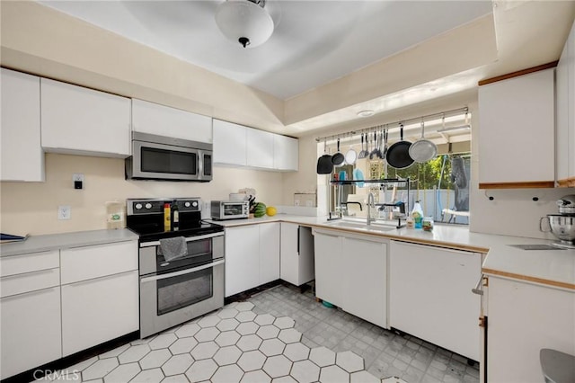 1411 Woodcrest Ave, La Habra, CA 90631 - kitchen featuring appliances with stainless steel finishes, white cabinetry, and light countertops