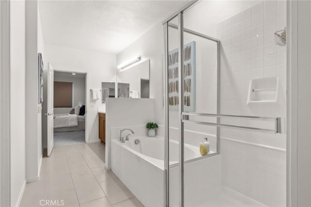13028 Central Ave Unit 202, Hawthorne, CA 90250 - ensuite bathroom featuring a shower stall, a bath, vanity, and tile patterned flooring