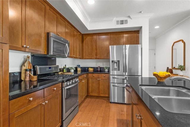 13028 Central Ave Unit 202, Hawthorne, CA 90250 - kitchen with appliances with stainless steel finishes, crown molding, light wood finished floors, brown cabinetry, and recessed lighting