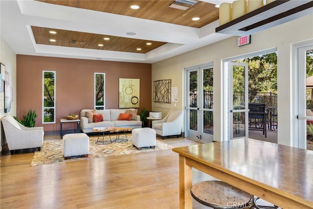 13028 Central Ave Unit 202, Hawthorne, CA 90250 - living area featuring a tray ceiling, french doors, plenty of natural light, wooden ceiling, and wood finished floors