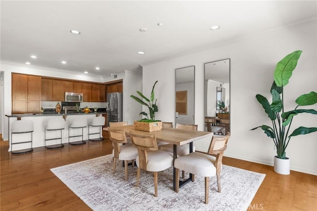 13028 Central Ave Unit 202, Hawthorne, CA 90250 - dining room with crown molding, recessed lighting, and wood finished floors