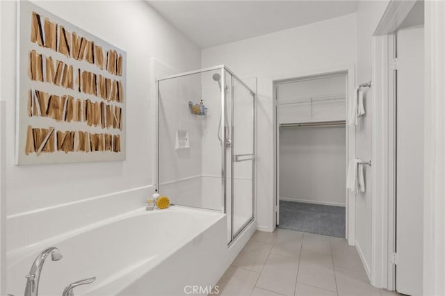 13028 Central Ave Unit 202, Hawthorne, CA 90250 - bathroom featuring a stall shower, a garden tub, a walk in closet, and tile patterned floors