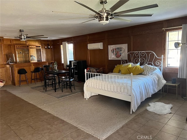 9535 Timberlane Ave, Hesperia, CA 92345 - bedroom featuring tile patterned flooring, an AC wall unit, a textured ceiling, and wooden walls