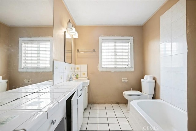 1811 Elaine St, Pomona, CA 91767 - bathroom featuring vanity, a tub to relax in, tile patterned flooring, and ornamental molding