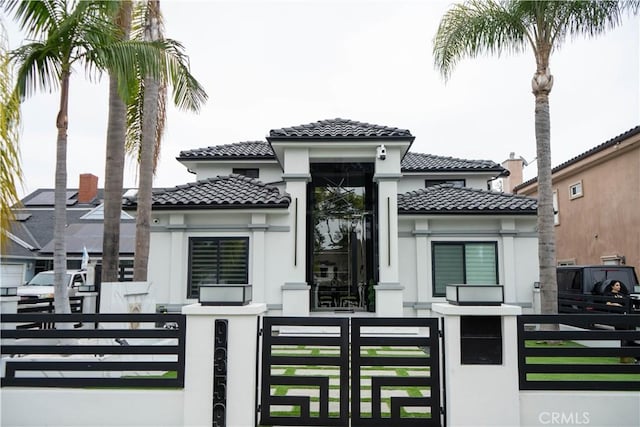 9359 Cecilia St, Downey, CA 90241 - mediterranean / spanish house with a tiled roof, stucco siding, a fenced front yard, and a gate