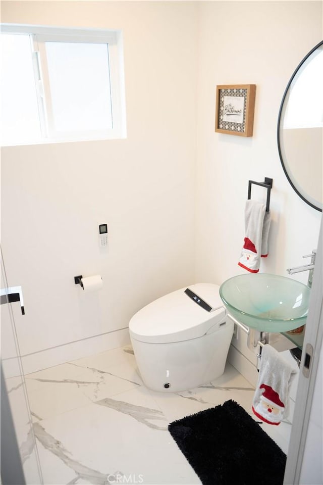 9359 Cecilia St, Downey, CA 90241 - bathroom with marble look tile flooring and toilet
