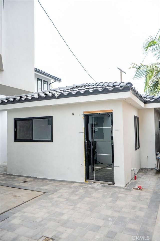 9359 Cecilia St, Downey, CA 90241 - back of house featuring a patio area, stucco siding, and a tiled roof