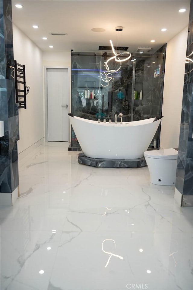 9359 Cecilia St, Downey, CA 90241 - full bath with marble tiled floors, a towel warming rack, a freestanding bath, and recessed lighting