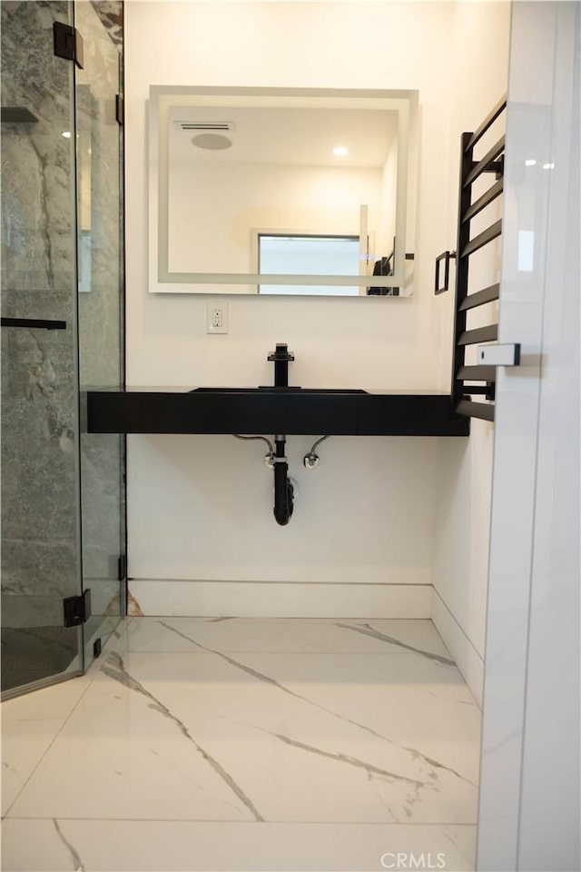 9359 Cecilia St, Downey, CA 90241 - bathroom featuring a towel warming rack, marble look tiles, and a marble finish shower
