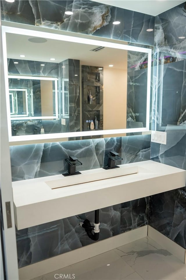 9359 Cecilia St, Downey, CA 90241 - bathroom with marble look tile flooring, tile walls, and vanity