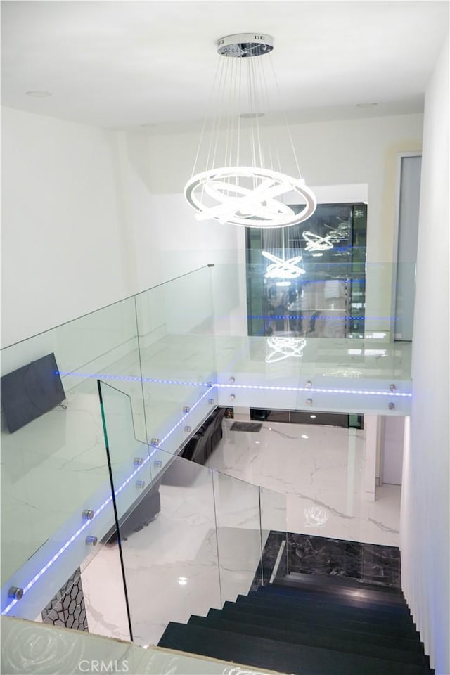 9359 Cecilia St, Downey, CA 90241 - stairway featuring a chandelier and marble look tile flooring
