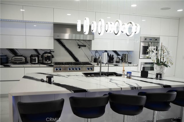 9359 Cecilia St, Downey, CA 90241 - kitchen featuring modern cabinets, stainless steel appliances, white cabinetry, an island with sink, and pendant lighting