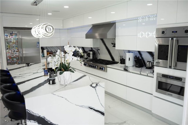 9359 Cecilia St, Downey, CA 90241 - kitchen with wall chimney exhaust hood, appliances with stainless steel finishes, modern cabinets, white cabinetry, and recessed lighting