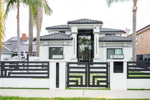 9359 Cecilia St, Downey, CA 90241 - view of front of property featuring a tile roof, stucco siding, a gate, and a fenced front yard