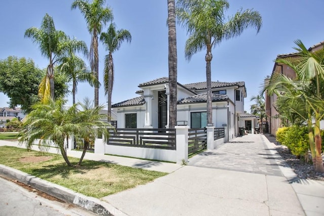 9359 Cecilia St, Downey, CA 90241 - mediterranean / spanish-style home with a fenced front yard, a tile roof, stucco siding, and a gate