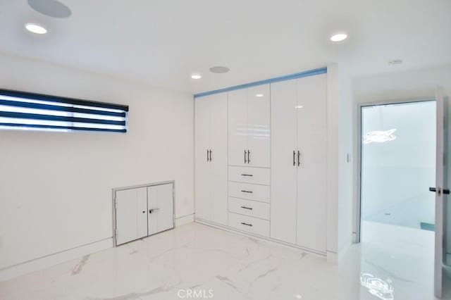 9359 Cecilia St, Downey, CA 90241 - unfurnished bedroom with light marble finish floors, recessed lighting, and a closet