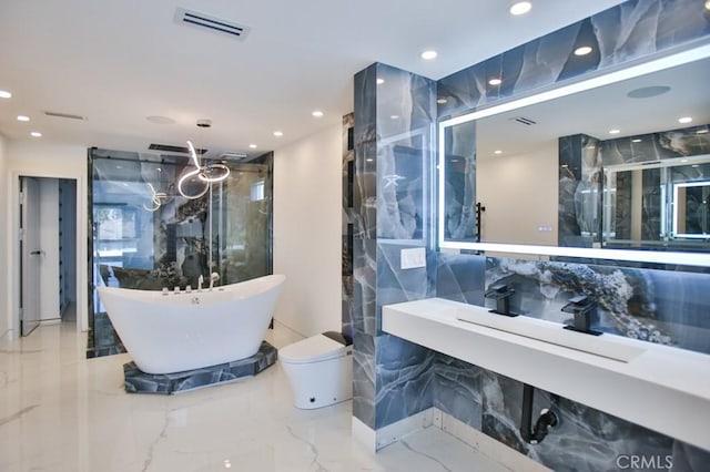 9359 Cecilia St, Downey, CA 90241 - full bathroom with marble tiled floors, a freestanding tub, a marble finish shower, tile walls, and recessed lighting