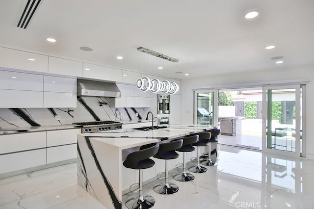 9359 Cecilia St, Downey, CA 90241 - kitchen with modern cabinets, light marble finish flooring, white cabinets, recessed lighting, and a center island with sink