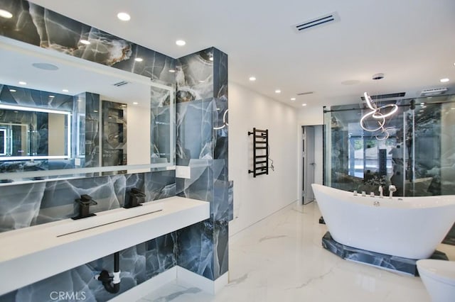 9359 Cecilia St, Downey, CA 90241 - bathroom featuring marble tiled flooring, a marble finish shower, a soaking tub, a towel warming rack, and recessed lighting
