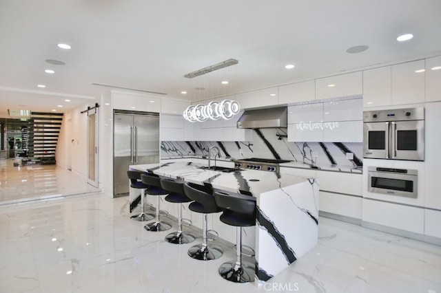 9359 Cecilia St, Downey, CA 90241 - kitchen with modern cabinets, appliances with stainless steel finishes, wall chimney range hood, white cabinetry, and recessed lighting
