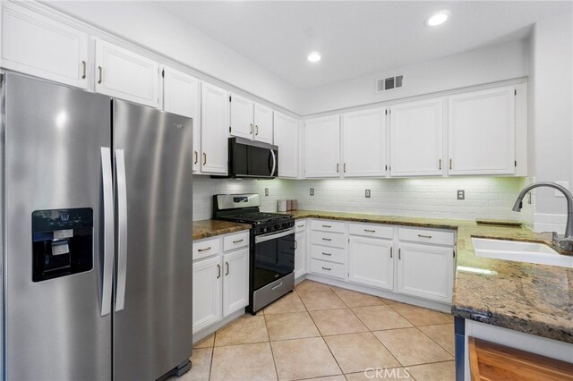 3 Kyle Ct, Ladera Ranch, CA 92694 - kitchen with stainless steel appliances, dark stone countertops, white cabinets, backsplash, and recessed lighting