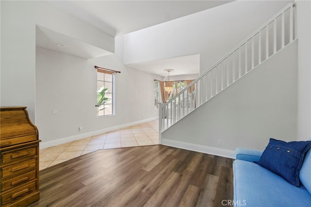 3 Kyle Ct, Ladera Ranch, CA 92694 - unfurnished living room featuring stairway, wood finished floors, and a chandelier