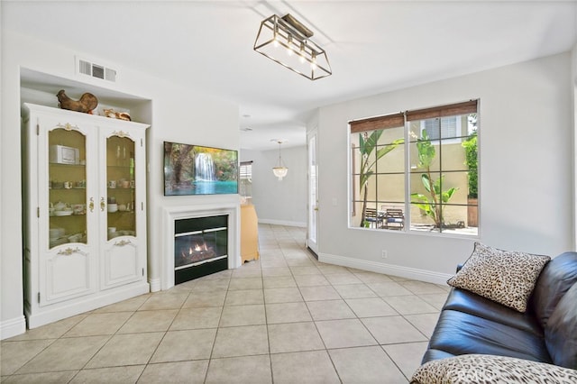 3 Kyle Ct, Ladera Ranch, CA 92694 - living room featuring healthy amount of natural light, light tile patterned floors, and a glass covered fireplace