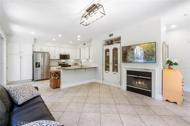 3 Kyle Ct, Ladera Ranch, CA 92694 - living area featuring light tile patterned flooring, recessed lighting, and a glass covered fireplace