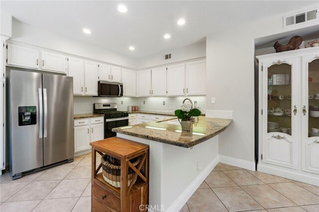 3 Kyle Ct, Ladera Ranch, CA 92694 - kitchen with appliances with stainless steel finishes, light tile patterned floors, a peninsula, stone counters, and white cabinets