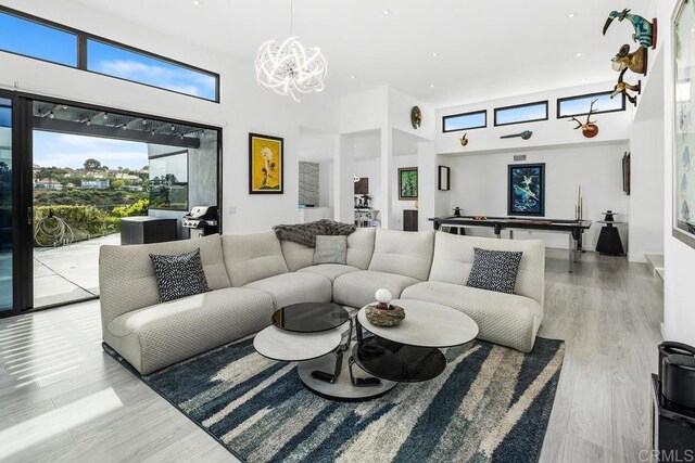 6544 Caminito Northland Ln, Jolla, CA 92037 - living room with a towering ceiling, a chandelier, wood finished floors, pool table, and recessed lighting