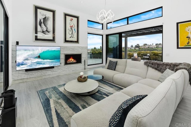 6544 Caminito Northland Ln, Jolla, CA 92037 - living room featuring a chandelier, a high end fireplace, and wood finished floors