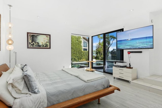 6544 Caminito Northland Ln, Jolla, CA 92037 - bedroom featuring a wall of windows, light wood-style flooring, and access to outside