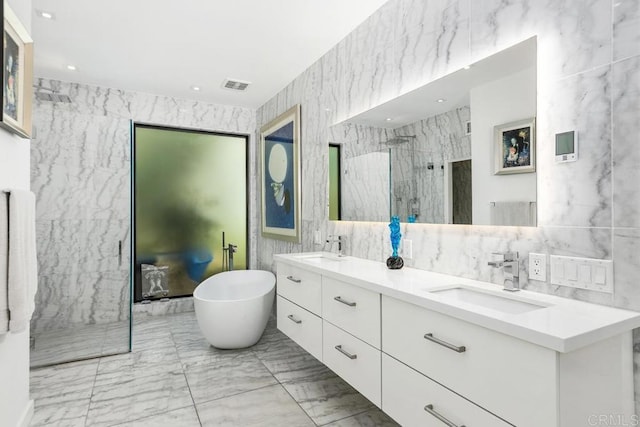 6544 Caminito Northland Ln, Jolla, CA 92037 - full bathroom featuring tile walls, marble finish flooring, double vanity, a marble finish shower, and a freestanding tub