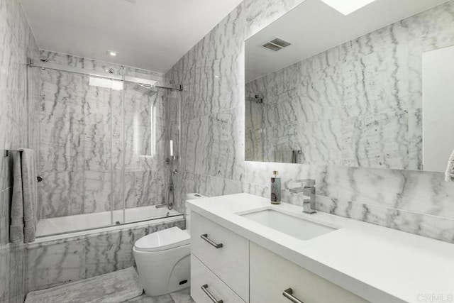 6544 Caminito Northland Ln, Jolla, CA 92037 - full bath featuring bath / shower combo with glass door, vanity, marble finish floors, and tile walls