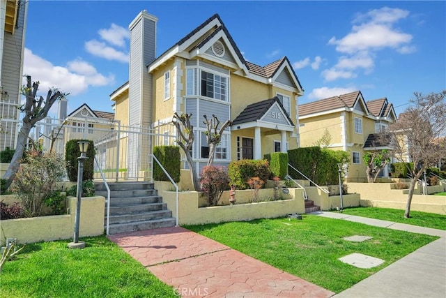 519 Sefton Ave Unit D, Monterey Park, CA 91755 - view of front facade with a chimney, a front yard, stucco siding, and a residential view