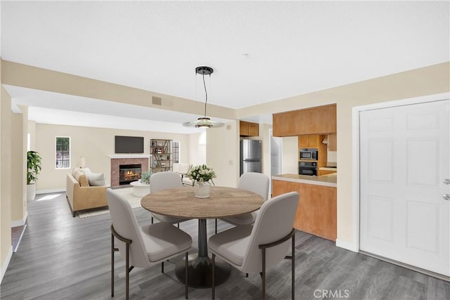 519 Sefton Ave Unit D, Monterey Park, CA 91755 - dining area with dark wood-style floors and a glass covered fireplace