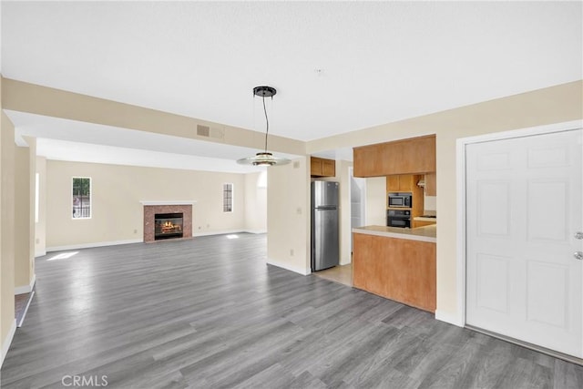519 Sefton Ave Unit D, Monterey Park, CA 91755 - unfurnished living room featuring wood finished floors and a fireplace with flush hearth