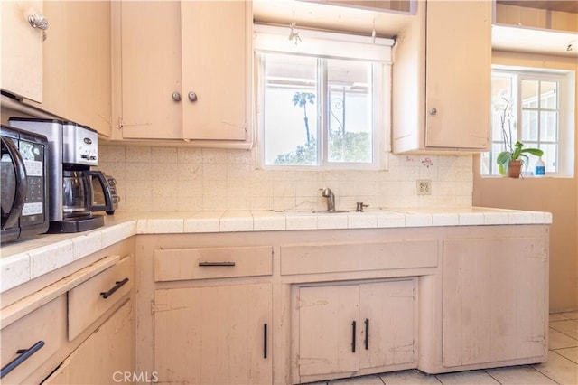 6644 Bothwell Rd, Reseda, CA 91335 - kitchen with tile countertops, tasteful backsplash, and black microwave