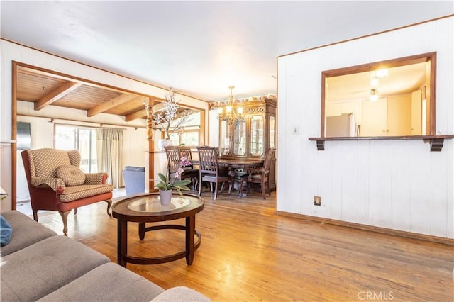 6644 Bothwell Rd, Reseda, CA 91335 - living room featuring a chandelier, wood finished floors, beamed ceiling, and wooden walls