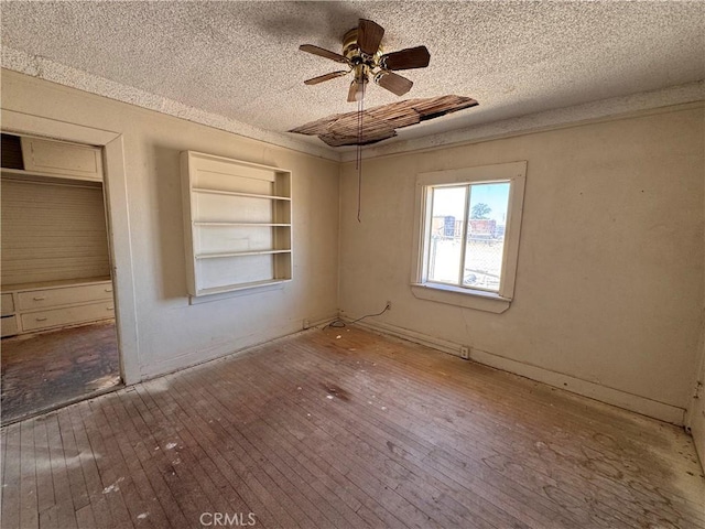 29095 Arrowhead Ave, Barstow, CA 92311 - spare room featuring hardwood / wood-style flooring, a textured ceiling, and ceiling fan