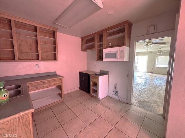 29095 Arrowhead Ave, Barstow, CA 92311 - kitchen featuring open shelves, white microwave, light tile patterned floors, and ceiling fan