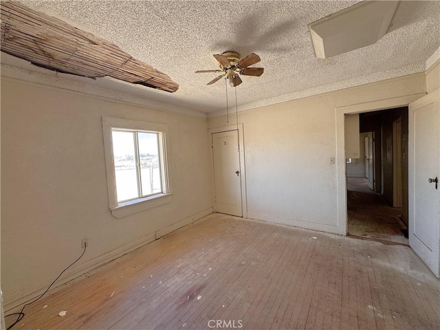 29095 Arrowhead Ave, Barstow, CA 92311 - empty room with wood-type flooring, ceiling fan, and a textured ceiling