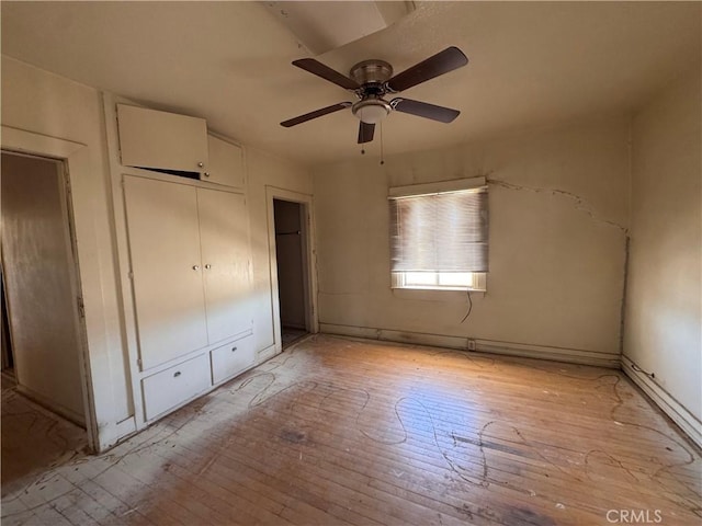29095 Arrowhead Ave, Barstow, CA 92311 - unfurnished bedroom with light wood-style flooring, a ceiling fan, and a closet