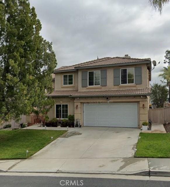 48 Villa Milano, Lake Elsinore, CA 92532 - view of front of house featuring a tile roof, a garage, driveway, and stucco siding