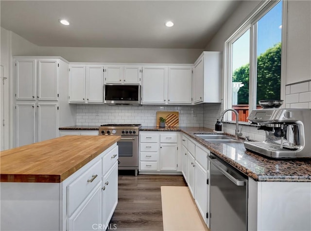 205 W Sparkleberry Ave, Orange, CA 92865 - kitchen with stainless steel appliances, butcher block countertops, dark wood-type flooring, white cabinets, and recessed lighting