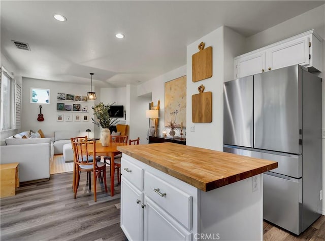 205 W Sparkleberry Ave, Orange, CA 92865 - kitchen with freestanding refrigerator, wooden counters, open floor plan, white cabinetry, and recessed lighting
