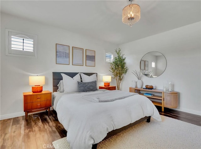 205 W Sparkleberry Ave, Orange, CA 92865 - bedroom with wood finished floors, multiple windows, and a chandelier