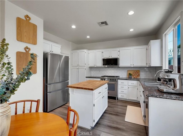 205 W Sparkleberry Ave, Orange, CA 92865 - kitchen with stainless steel appliances, butcher block counters, a center island, tasteful backsplash, and white cabinets