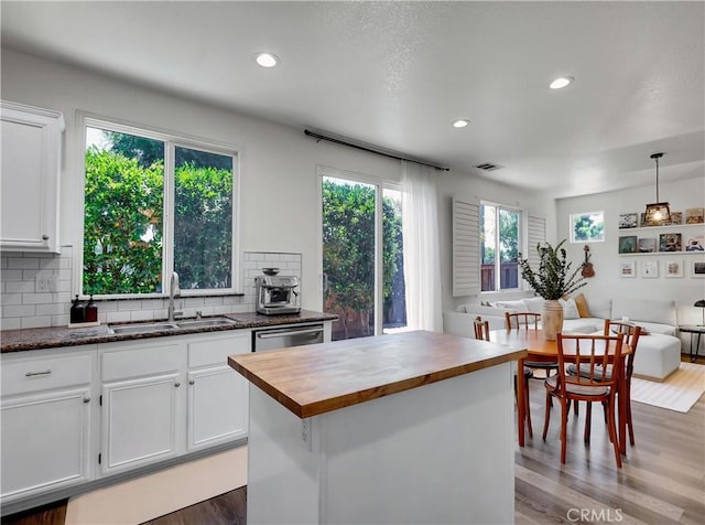 205 W Sparkleberry Ave, Orange, CA 92865 - kitchen featuring butcher block counters, wood finished floors, white cabinetry, decorative backsplash, and recessed lighting