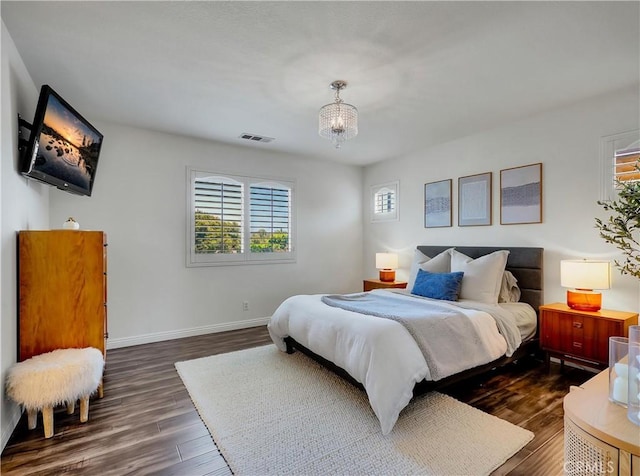 205 W Sparkleberry Ave, Orange, CA 92865 - bedroom with dark wood-style flooring and a chandelier